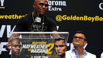 Jul 14, 2014; New York, NY, USA; Floyd Mayweather Jr. and Marcos Maidana (right) promote their upcoming welterweight rematch during a press conference at Times Square. Mandatory Credit: Noah K. Murray-USA TODAY Sports