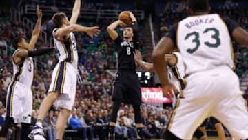 Jan 29, 2016; Salt Lake City, UT, USA; Minnesota Timberwolves guard Zach LaVine (8) shoots the ball against Utah Jazz guard Trey Burke (3) and center Jeff Withey (24) in the second quarter at Vivint Smart Home Arena. Mandatory Credit: Jeff Swinger-USA TODAY Sports