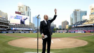 SAN DIEGO, CALIFORNIA - SEPTEMBER 29: San Diego Padres announcer Dick Enberg waves to the crowd during a ceremony held before a baseball game between the San Diego Padres and the Los Angeles Dodgers at PETCO Park on September 29, 2016 in San Diego, California. The Padres held the pre-game ceremony to honor Enberg's last home game as the team's primary play-by-play man for television broadcasts. (Photo by Denis Poroy/Getty Images)