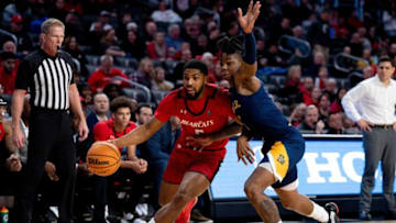 Cincinnati Bearcats guard David DeJulius drives on La Salle Explorers at Fifth Third Arena. The Enquirer.