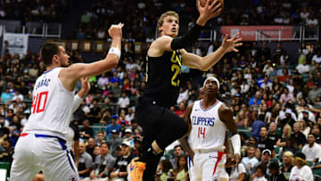 Oct 8, 2023; Honolulu, Hawaii, USA; Utah Jazz forward Lauri Markkanen (23) drives to the basket between Los Angeles Clippers center Ivica Zubac (40) and guard Terance Mann (14) during the first quarter at SimpliFi Arena at Stan Sheriff Center. Mandatory Credit: Steven Erler-USA TODAY Sports
