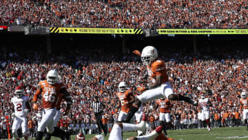 DALLAS, TEXAS - OCTOBER 12: D'Shawn Jamison #5 of the Texas Longhorns jumps over Jalen Hurts #1 of the Oklahoma Sooners in the second quarter during the 2019 AT&T Red River Showdown at Cotton Bowl on October 12, 2019 in Dallas, Texas. (Photo by Ronald Martinez/Getty Images)