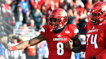 Nov 26, 2016; Louisville, KY, USA; Louisville Cardinals quarterback Lamar Jackson (8) strikes a pose after scoring a touchdown against the Kentucky Wildcats during the second half at Papa John