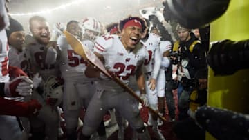 MINNEAPOLIS, MINNESOTA - NOVEMBER 30: Jonathan Taylor #23 of the Wisconsin Badgers celebrates defeating the Minnesota Golden Gophers with the Paul Bunyan Football Trophy in the game at TCF Bank Stadium on November 30, 2019 in Minneapolis, Minnesota. The Badgers defeated the Golden Gophers 38-17. (Photo by Hannah Foslien/Getty Images)