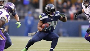 Nov 17, 2013; Seattle, WA, USA; Seattle Seahawks running back Marshawn Lynch (24) rushes against the Minnesota Vikings during the third quarter at CenturyLink Field. Mandatory Credit: Joe Nicholson-USA TODAY Sports