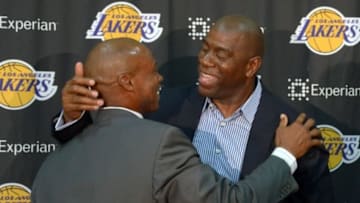 Jul 29, 2014; El Segundo, CA, USA; Byron Scott (left) is embraced by Magic Johnson at a press conference to introduce Scott as Los Angeles Lakers coach at Toyota Sports Center. Mandatory Credit: Kirby Lee-USA TODAY Sports