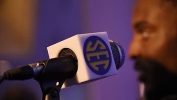 Jul 15, 2015; Birmingham, AL, USA; General view of a microphone with an SEC logo while Kentucky Wildcats safety A.J. Stamps (background) speaks to media during SEC media day at the Wynfrey Hotel. Mandatory Credit: Shanna Lockwood-USA TODAY Sports