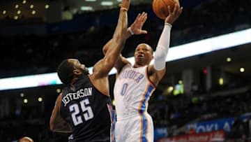 Mar 2, 2014; Oklahoma City, OK, USA; Oklahoma City Thunder point guard Russell Westbrook (0) attempts a shot against Charlotte Bobcats center Al Jefferson (25) during the fourth quarter at Chesapeake Energy Arena. Mandatory Credit: Mark D. Smith-USA TODAY Sports