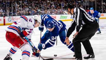 TORONTO, ON - DECEMBER 28: Auston Matthews #34 of the Toronto Maple Leafs takes a face off against Filip Chytil #72 of the New York Rangers during the second period at the Scotiabank Arena on December 28, 2019 in Toronto, Ontario, Canada. (Photo by Kevin Sousa/NHLI via Getty Images)