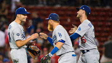 BOSTON, MA - JULY 15: Joe Kelly #17 celebrates with teammates Justin Turner #10 and Cody Bellinger #35 of the Los Angeles Dodgers after beating the Boston Red Sox in twelve innings at Fenway Park on July 15, 2019 in Boston, Massachusetts. (Photo by Kathryn Riley/Getty Images)