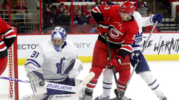 RALEIGH, NC - NOVEMBER 21: Warren Foegele #13 of the Carolina Hurricanes looks to chip a puck past Frederik Andersen #31 of the Toronto Maple Leafs during an NHL game on November 21, 2018 at PNC Arena in Raleigh, North Carolina. (Photo by Gregg Forwerck/NHLI via Getty Images)