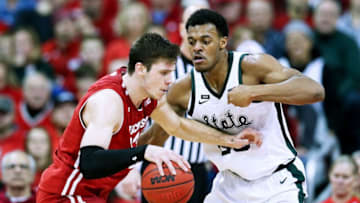 MADISON, WISCONSIN - FEBRUARY 12: Ethan Happ #22 of the Wisconsin Badgers dribbles the ball while being guarded by Xavier Tillman #23 of the Michigan State Spartans in the second half at the Kohl Center on February 12, 2019 in Madison, Wisconsin. (Photo by Dylan Buell/Getty Images)