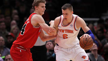 CHICAGO, IL - DECEMBER 09: Kristaps Porzingis #6 of the New York Knicks dribbles the ball while being guarded by Lauri Markkanen #24 of the Chicago Bulls in the third quarter at the United Center on December 9, 2017 in Chicago, Illinois. (Photo by Dylan Buell/Getty Images)