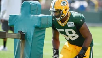 Jul 30, 2014; Green Bay, WI, USA; Green Bay Packer linebacker Sam Barrington hits a blocking dummy during training camp at Ray Nitschke Field. Mandatory Credit: Benny Sieu-USA TODAY Sports