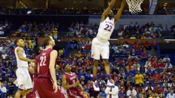 Mar 21, 2014; St. Louis, MO, USA; Kansas Jayhawks guard Andrew Wiggins (22) dunks the ball past Eastern Kentucky Colonels guard Marcus Lewis (12) in the first half during the 2nd round of the 2014 NCAA Men