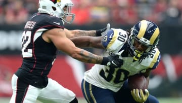 Oct 2, 2016; Glendale, AZ, USA; Arizona Cardinals free safety Tyrann Mathieu (32) attempts to tackle Los Angeles Rams running back Todd Gurley (30) during the second half at University of Phoenix Stadium. The Rams won 17-13. Mandatory Credit: Joe Camporeale-USA TODAY Sports