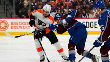 Mar 25, 2022; Denver, Colorado, USA; Colorado Avalanche left wing J.T. Compher (37) shoots past Philadelphia Flyers defenseman Travis Sanheim (6) in the second period at Ball Arena. Mandatory Credit: Ron Chenoy-USA TODAY Sports