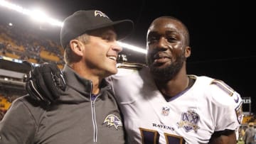 Oct 1, 2015; Pittsburgh, PA, USA; Baltimore Ravens head coach John Harbaugh (L) and wide receiver Kamar Aiken (11) celebrate while leaving the field after defeating the Pittsburgh Steelers at Heinz Field. The Ravens won 23-20 in overtime. Mandatory Credit: Charles LeClaire-USA TODAY Sports