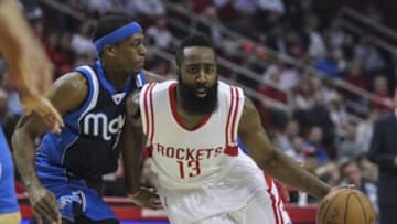 Jan 28, 2015; Houston, TX, USA; Houston Rockets guard James Harden (13) drives to the basket during the first quarter as Dallas Mavericks guard Rajon Rondo (9) defends at Toyota Center. Mandatory Credit: Troy Taormina-USA TODAY Sports