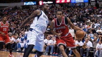 Dec 14, 2013; Dallas, TX, USA; Milwaukee Bucks power forward John Henson (31) drives to the basket past Dallas Mavericks center DeJuan Blair (45) during the game at the American Airlines Center. The Mavericks defeated the Bucks 106-93. Mandatory Credit: Jerome Miron-USA TODAY Sports