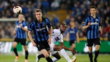 BRUGGE, BELGIUM - APRIL 16: Bjorn Engels of Club Brugge and Ilombe Pele Mboyo of Racing Genk battle for the ball during the Jupiler League match between Club Brugge v Racing Genk at the Jan Breydel Stadium on April 16, 2014 in Brugge, Belgium. (Photo by Dean Mouhtaropoulos/Getty Images)