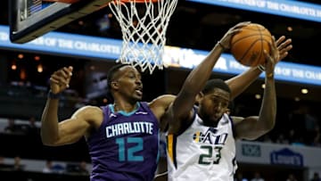CHARLOTTE, NC - JANUARY 12: Dwight Howard #12 of the Charlotte Hornets goes after the ball against Royce O'Neale #23 of the Utah Jazz during their game at Spectrum Center on January 12, 2018 in Charlotte, North Carolina. NOTE TO USER: User expressly acknowledges and agrees that, by downloading and or using this photograph, User is consenting to the terms and conditions of the Getty Images License Agreement. (Photo by Streeter Lecka/Getty Images)