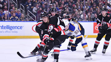 Nov 23, 2022; Buffalo, New York, USA; Buffalo Sabres defenseman Henri Jokiharju (10) clears the puck against the St. Louis Blues in the third period at KeyBank Center. Mandatory Credit: Mark Konezny-USA TODAY Sports