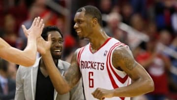 Jan 18, 2014; Houston, TX, USA; Houston Rockets forward Terrence Jones (6) celebrates a score with teammate Patrick Beverley (suit) during the second half against the Milwaukee Bucks at Toyota Center. The Rockets won 114-104. Mandatory Credit: Soobum Im-USA TODAY Sports