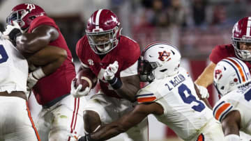 Auburn footballNov 28, 2020; Tuscaloosa, Alabama, USA; Alabama running back Brian Robinson Jr. (4) is tackled by Auburn linebacker Zakoby McClain (9) at Bryant-Denny Stadium in the Iron Bowl. Mandatory Credit: Mickey Welsh/The Montgomery Advertiser via USA TODAY Sports