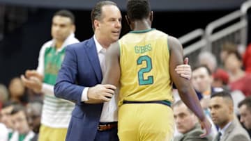 LOUISVILLE, KY - MARCH 04: Mike Brey the head coach of the Notre Dame Fighting Irish talks with T.J. Gibbs