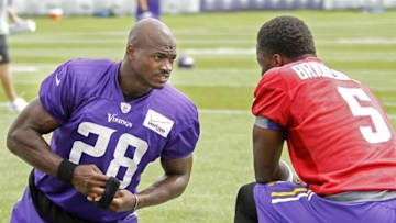 Jul 27, 2015; Mankato, MN, USA; Minnesota Vikings running back Adrian Peterson (28) talks with quarterback Teddy Bridgewater (5) before drills at training camp at Minnesota State University. Mandatory Credit: Bruce Kluckhohn-USA TODAY Sports