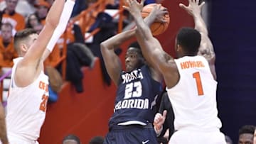 Dec 3, 2016; Syracuse, NY, USA; North Florida Ospreys guard Nick Malonga (23) is closely defended by Syracuse Orange forward Tyler Lydon (20) and guard Frank Howard (1) during the first half of a game at the Carrier Dome. Mandatory Credit: Mark Konezny-USA TODAY Sports