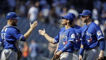 Aug 17, 2016; Bronx, NY, USA; Toronto Blue Jays third baseman Darwin Barney (18) and catcher Russell Martin (55) celebrate their win over the New York Yankees at Yankee Stadium. Mandatory Credit: Adam Hunger-USA TODAY Sports
