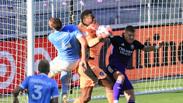 May 8, 2021; Orlando, Florida, USA; New York City goalkeeper Sean Johnson (1) saves the ball between defender Maxime Chanot (4) and Orlando City forward Chris Mueller (9) at Orlando City Stadium. Mandatory Credit: Matt Stamey-USA TODAY Sports