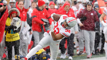 Nov 27, 2021; Ann Arbor, Michigan, USA; Ohio State Buckeyes running back TreVeyon Henderson (32) rush the ball passed Michigan Wolverines defensive back Rod Moore (19) in the first half at Michigan Stadium. Mandatory Credit: Rick Osentoski-USA TODAY Sports