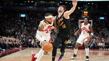 Nov 28, 2022; Toronto, Ontario, CAN; Toronto Raptors guard Gary Trent Jr. (33) drives against Cleveland Cavaliers forward Cedi Osman (16) during the second half at Scotiabank Arena. Mandatory Credit: John E. Sokolowski-USA TODAY Sports