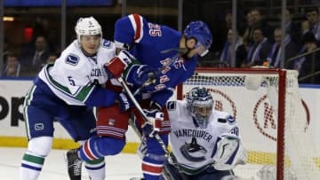 Jan 19, 2016; New York, NY, USA; Vancouver Canucks goalie Ryan Miller (30) makes a save on a shot by New York Rangers left wing Viktor Stalberg (25) who is defended by Canucks defenseman Luca Sbisa (5) during the second period of an NHL hockey game at Madison Square Garden. Mandatory Credit: Adam Hunger-USA TODAY Sports