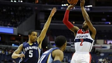 Mar 3, 2014; Washington, DC, USA; Washington Wizards point guard John Wall (2) shoots as Memphis Grizzlies shooting guard Courtney Lee (5) defends during the first half at Verizon Center. Mandatory Credit: Brad Mills-USA TODAY Sports