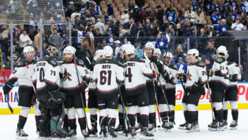Oct 17, 2022; Toronto, Ontario, CAN; Arizona Coyotes goaltender Karel Vejmelka (70) celebrates the win with Arizona Coyotes center Liam O'Brien (38) against the Toronto Maple Leafs at the end of the third period at the Scotiabank Arena. Mandatory Credit: Nick Turchiaro-USA TODAY Sports