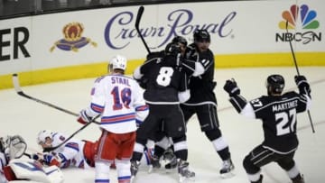 Jun 13, 2014; Los Angeles, CA, USA; Los Angeles Kings right wing Marian Gaborik (12) celebrates with teammates Drew Doughty (8) , Anze Kopitar (11) and Alec Martinez (27) after scoring a goal against the New York Rangers during the third period in game five of the 2014 Stanley Cup Final at Staples Center. Mandatory Credit: Richard Mackson-USA TODAY Sports