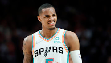 Mar 23, 2022; Portland, Oregon, USA; San Antonio Spurs point guard Dejounte Murray (5) reacts to a fan during the second half against the Portland Trail Blazers at Moda Center. Mandatory Credit: Soobum Im-USA TODAY Sports