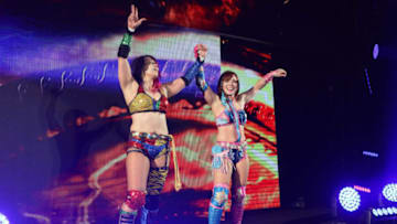 SINGAPORE - JUNE 27: (R-L) Kairi Sane and Asuka reacts after defeating Ilconics during the WWE Live Singapore at the Singapore Indoor Stadium on June 27, 2019 in Singapore. (Photo by Suhaimi Abdullah/Getty Images for Singapore Sports Hub)