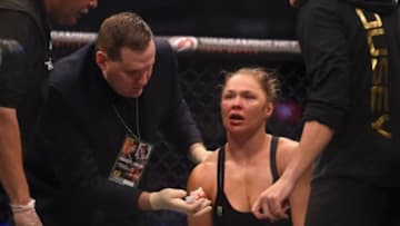 Nov 15, 2015; Melbourne, Australia; Ronda Rousey (red gloves) receives attention after being defeated by Holly Holm (not pictured) during UFC 193 at Etihad Stadium. Mandatory Credit: Matt Roberts-USA TODAY Sports
