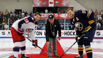 CLINTON, NY - SEPTEMBER 25: Mike Orsino participates in a ceremonial puck drop with Boone Jenner #38 of the Columbus Blue Jackets and Jack Eichel #9 of the Buffalo Sabres before a preseason game during the NHL Kraft Hockeyville USA at Clinton Arena on September 25, 2018 in Clinton, New York. (Photo by Patrick McDermott/NHLI via Getty Images)