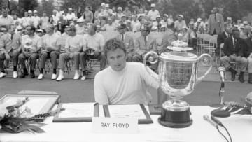 1969: Ray Floyd sits on a table next to the Annual Championship of the Professional Golfers Association of America, Rodman Wanamaker Trophy as he wins the 1969 PGA championship. (Photo by Martin Mills/Getty Images)