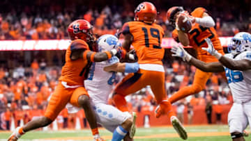SYRACUSE, NY - OCTOBER 20: Syracuse Orange and North Carolina Tar Heels players battle in the air for a pass thrown by Nathan Elliott #11 of the North Carolina Tar Heels during overtime at the Carrier Dome on October 20, 2018 in Syracuse, New York. Syracuse defeats North Carolina in overtime 40-37. (Photo by Brett Carlsen/Getty Images)