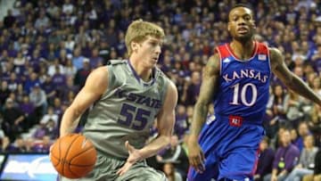 Feb 10, 2014; Manhattan, KS, USA; Kansas State Wildcats guard Will Spradling (55) drives to the basket against Kansas Jayhawks guard Naadir Tharpe (10) during first-half action at Fred Bramlage Coliseum. Mandatory Credit: Scott Sewell-USA TODAY Sports