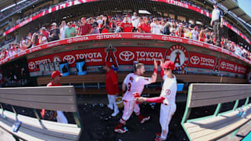 ANAHEIM, CA - SEPTEMBER 30: Taylor Ward #3 of the Los Angeles Angels of Anaheim is congratulated by teammate Shohei Ohtani #17 in dugout after Ward hit a walk-off home run during the ninth inning of the the MLB game against the Oakland Athletics at Angel Stadium on September 30, 2018 in Anaheim, California. The Angels defeated the Athletics 5-4. (Photo by Victor Decolongon/Getty Images)