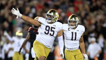 LOUISVILLE, KENTUCKY - SEPTEMBER 02: Myron Tagovailoa-Amosa #95 and Alohi Gilman #11 of the Notre Dame Fighting Irish celebrate after the Irish recovered a fumble against the Louisville Cardinals on September 02, 2019 in Louisville, Kentucky. (Photo by Andy Lyons/Getty Images)