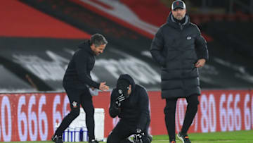 SOUTHAMPTON, ENGLAND - JANUARY 04: Ralph Hasenhuttl, Manager of Southampton celebrates victory with his assistant manager Richard Kitzbichler as Jurgen Klopp, Manager of Liverpool reacts after the Premier League match between Southampton and Liverpool at St Mary's Stadium on January 04, 2021 in Southampton, England. The match will be played without fans, behind closed doors as a Covid-19 precaution. (Photo by Adam Davy - Pool/Getty Images)